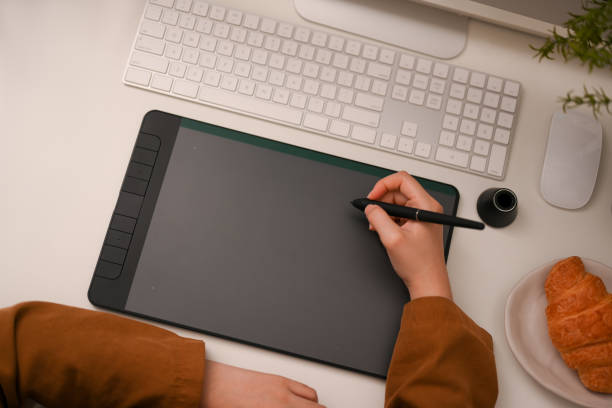 istock Female graphic designer, artist or architect using graphic tablet 1387570353