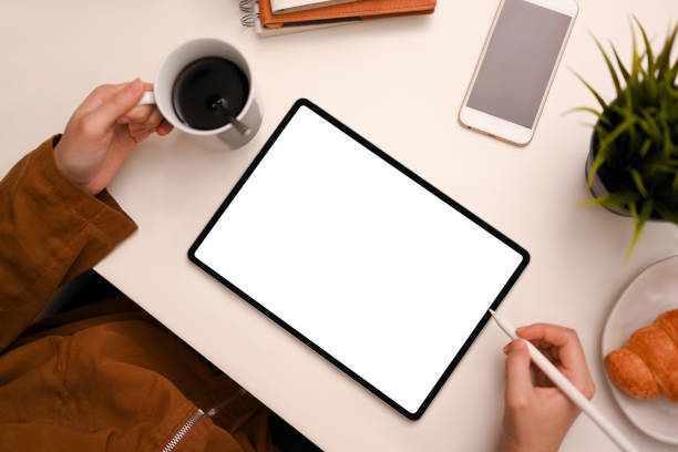 istock Female designer sipping coffee while designing her new collection on tablet 1387570361
