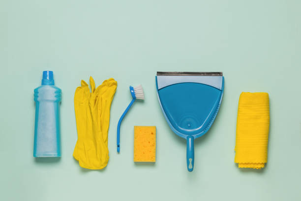 istock Yellow and blue cleaning and cleaning kit on a light background. Space for text. Flat lay. 1387572805