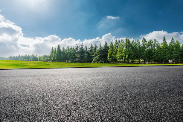 istock Asphalt road and green tree landscape 1387573710