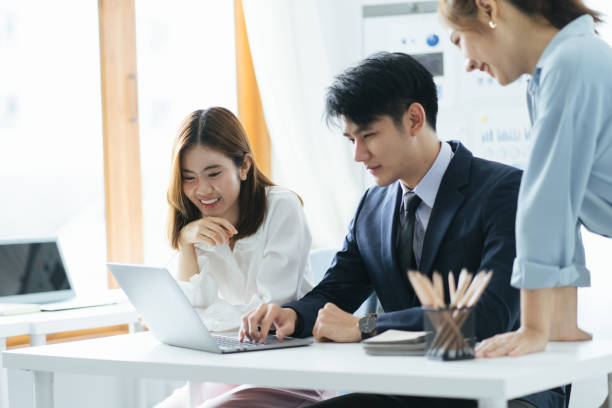 istock Smiling diverse colleagues gather in boardroom brainstorm discuss financial statistics together, happy multiracial coworkers have fun cooperating working together at office meeting, teamwork concept 1387573794