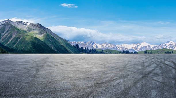 istock Asphalt road and snow mountain nature landscape 1387573826