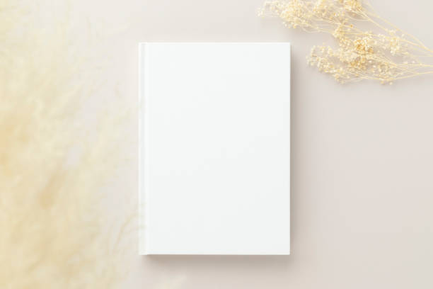 istock White book blank cover mockup on a beige background, flat lay, mockup 1387573856