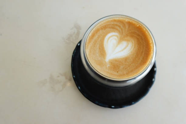 istock Latte art Coffee in HEART Shape , cream background 1387579573
