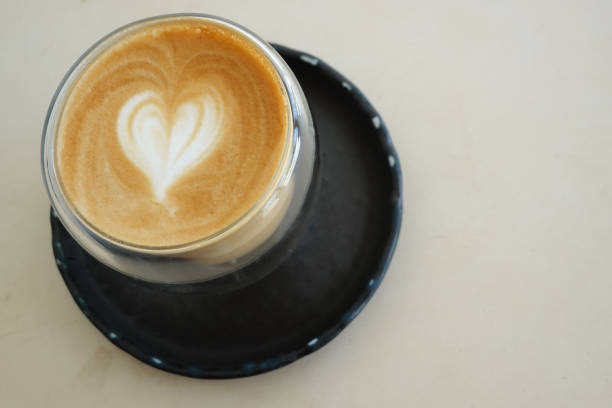 istock Latte art Coffee in HEART Shape , cream background 1387579590