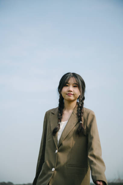 istock Asian female college students playing happily on the sunny grass 1387579697