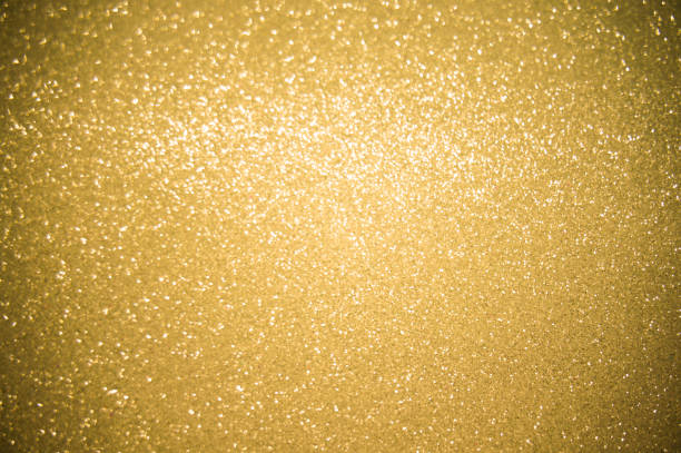 istock Gold glitters background. shimmering blur spot lights Bokeh Shiny gold light background. 1387580688