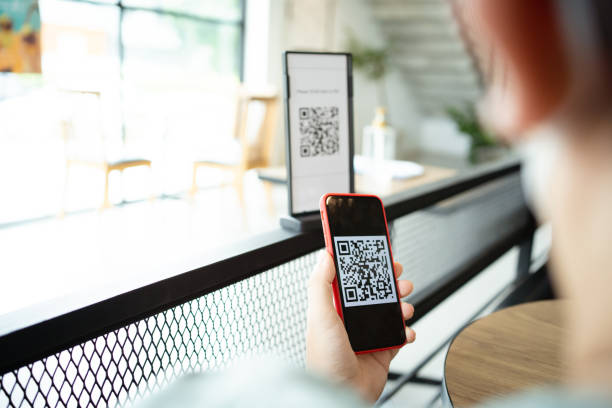 istock Qr code payment. E wallet. Man scanning tag accepted generate digital pay without money.scanning QR code online shopping cashless payment and verification technology concept 1387581070