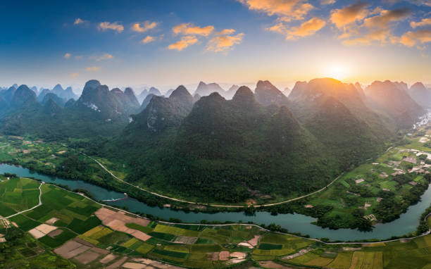 Aerial view of beautiful mountain and water natural landscape in Guilin at sunset Aerial view of beautiful mountain and water natural landscape in Guilin, China. Guilin is a world famous tourist resort. Here are the most widely distributed karst landforms in China. yangshuo stock pictures, royalty-free photos & images