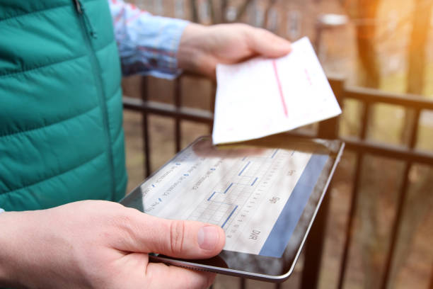 Truck driver checking electronic logbooks on a tablet stock photo