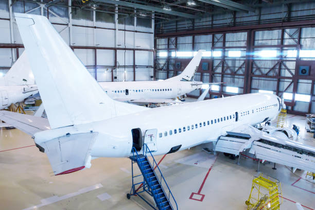 istock White passenger airliners in the hangar. Jet planes under maintenance 1387586109