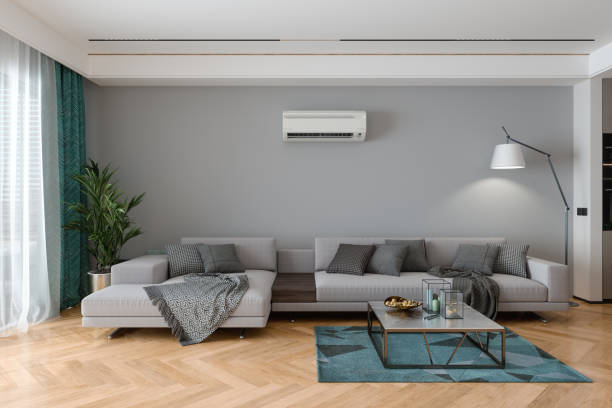 modernes wohnzimmerinterieur mit klimaanlage, grauem sofa, stehlampe und topfpflanze - air conditioner window heat hot day stock-fotos und bilder