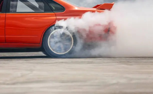 Race drift car burning tires on speed track