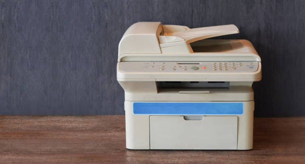 front view white and blue printer on wooden floor, grey wooden wall background,object, background,technology background, business, copy space