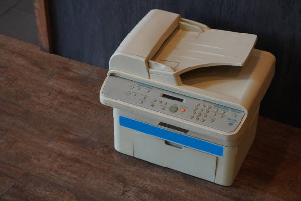istock old white and blue printer on wooden floor background,object, background,technology background, business, copy space 1387593197