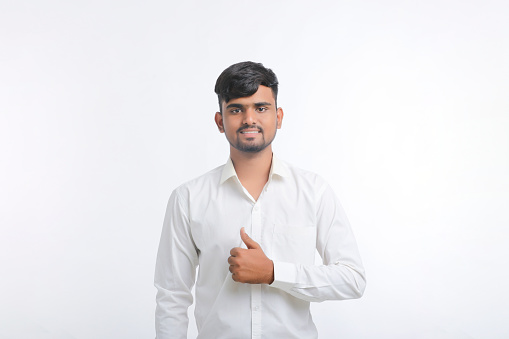 Young indian college student showing thumps up.