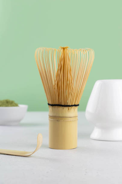istock Matcha tea powder, whisk, spoon on green background, selective focus. Organic matcha green tea ceremony. 1387604216