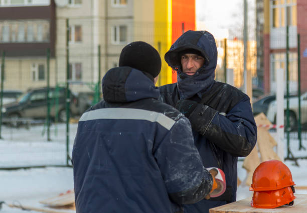 istock Two workers are talking at the assembly site of the ice town 1387605429