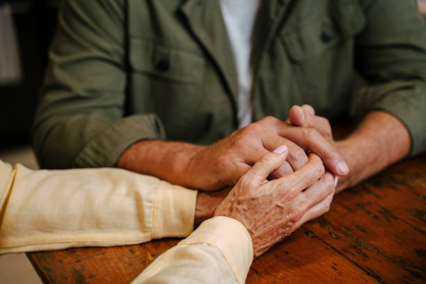 istock caucasian senior couple holding hands in kitchen 1387606734