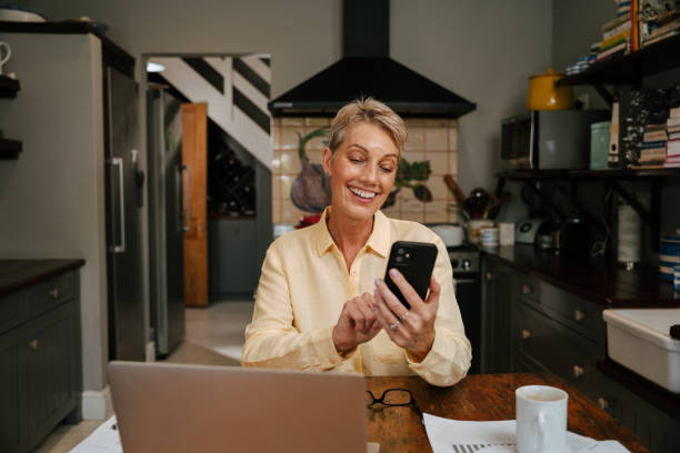 istock caucasian senior woman texting on cellular device 1387606793