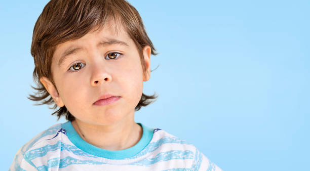 istock portrait of a boy with sad emotion 1387606813