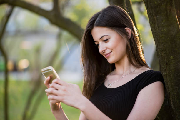 istock Young woman with smart phone in spring 1387607743
