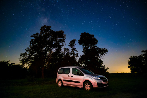 Krasnodar region. Russia. August 25, 2021. Silver car Opel Combo Life model under the starry sky. Comfortable modern car for traveling at night against the background of the starry sky.