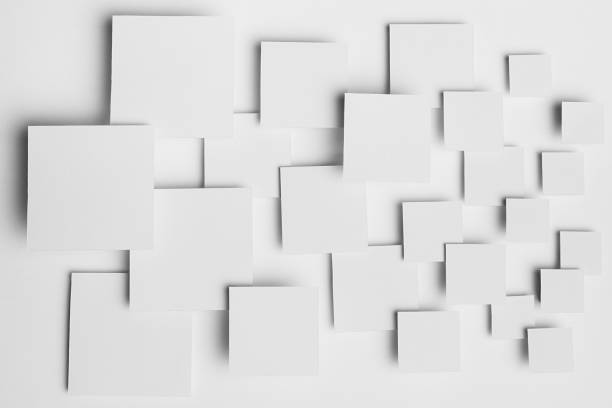 istock White abstract background - geometric pattern of different size squares in light with soft shadows, top view. Simple minimal backdrop for advertising, design. 1387607920