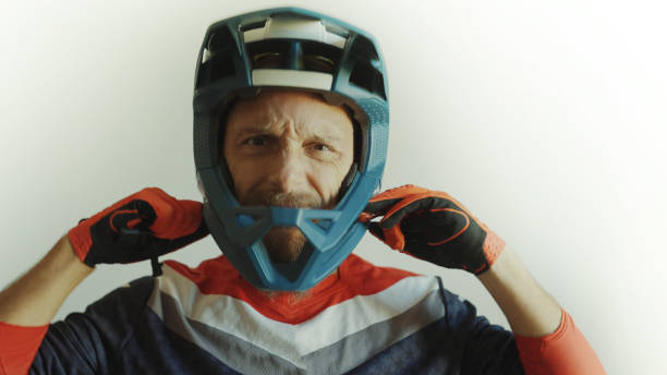 istock Man wearing a motocross enduro helmet on white background 1387607988