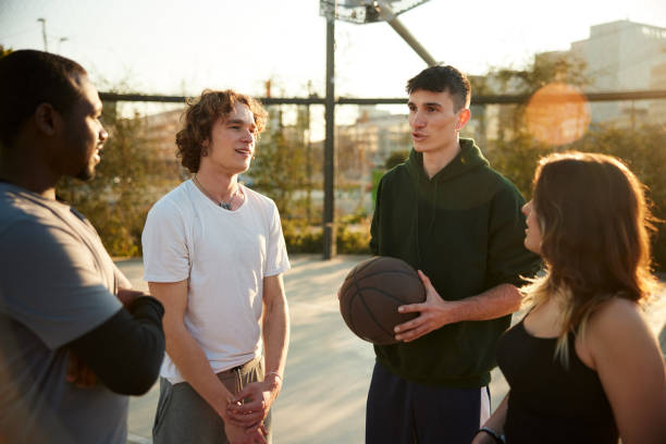 istock A group of four friends stand and take a break from a match 1387609393
