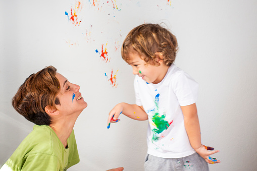 Mother and son doing finger painting