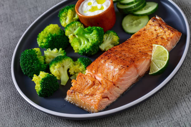 istock roast salmon fillet with boiled broccoli and sauce 1387611106
