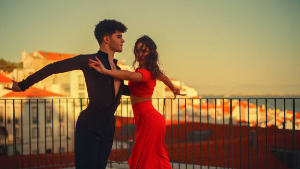 Beautiful Couple Dancing a Latin Dance Outside the City with Old Town in the Background. Sensual Dance by Two Professional Dancers on a Sunset in Ancient Culturally Rich Tourist Location. Beautiful Couple Dancing a Latin Dance Outside the City with Old Town in the Background. Sensual Dance by Two Professional Dancers on a Sunset in Ancient Culturally Rich Tourist Location. rumba photos stock pictures, royalty-free photos & images