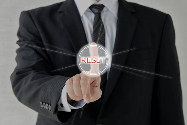 Business man puhing reset button stock photo