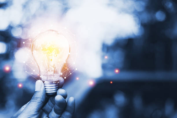istock Hand holding a light bulb, ideas of new ideas with innovative technology and creativity. concept creativity with bulbs that shine glitter and Technological lattice in today's life. 1387613967