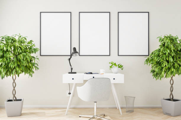 istock Three blank picture frame mockups on a beige structured wall with a writing desk, chair and two fig trees . 1387615378