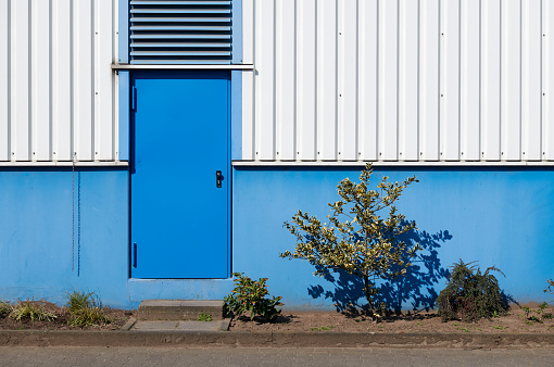 Blue door of an industrial building.