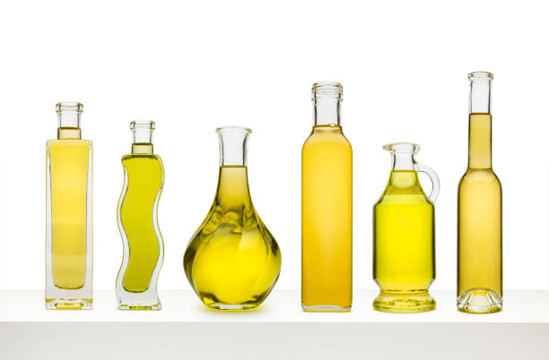 Olive oil and vinegar dispensers with tags isolated on gray background.