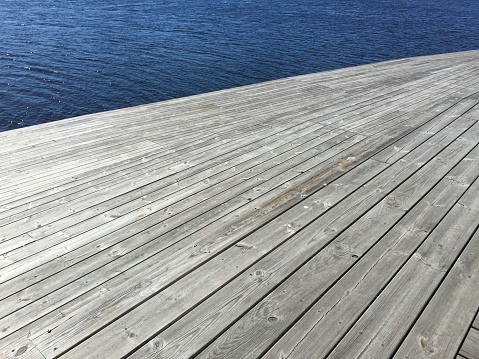 An unusual angle of a simple boardwalk.  Taken in Jönköping in Sweden this boardwalk forms a very pleasant walk along the river.