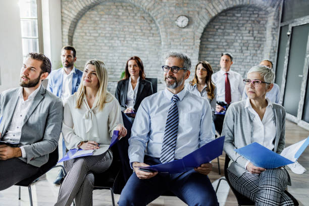 istock Happy entrepreneurs having training class in board room. 1387618125