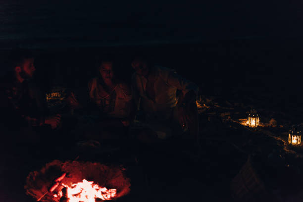 istock Sausages roasting on burning embers outdoors on a picnic 1387619298