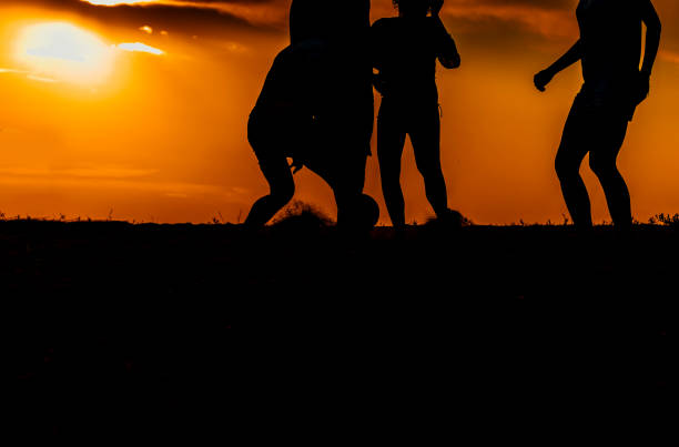 istock Soccer player with ball in action outdoors at the beach 1387619392