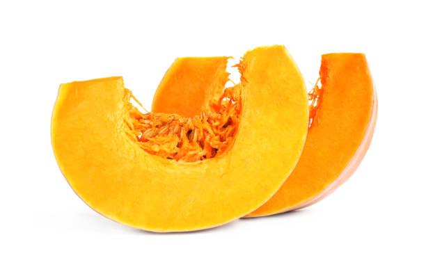 istock Pieces of ripe orange pumpkin on white background 1387620890