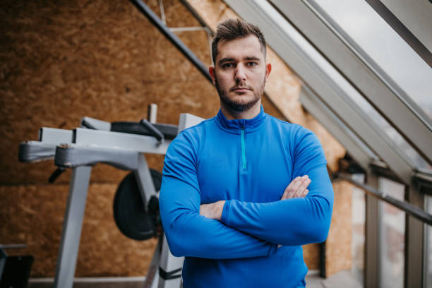 istock Man standing in gym 1387623515