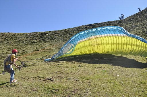 Mandi, Himachal Pradesh, India - 10 16 2021: A paraglider preparing for fly in the sky