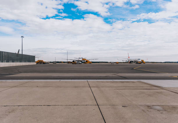 istock Airplanes parked on a airport runway 1387623703