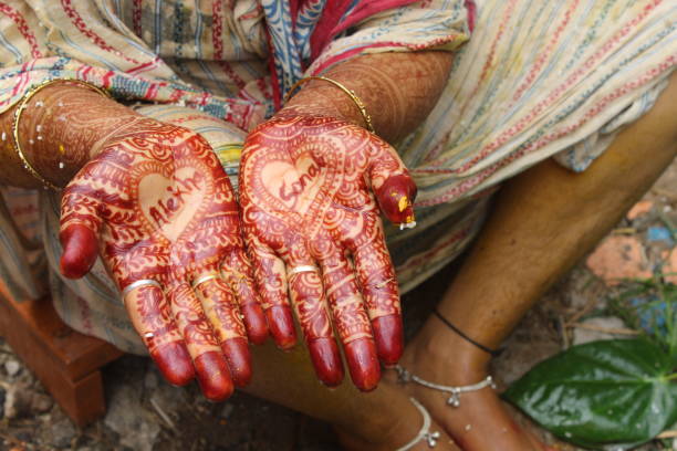 istock Indian traditional marriage system mahandi time. Two hand palm decorated by colour. 1387626124