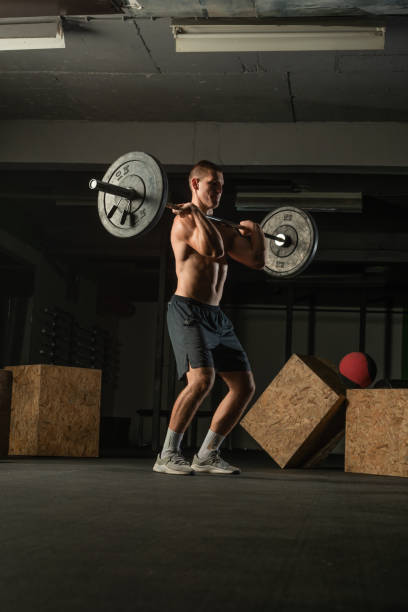 istock Fit strong shirtless athlete doing squats. Hardcore gym workout concept. 1387627820