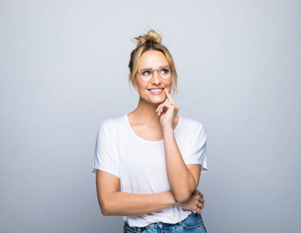 istock Smiling thoughtful blond woman looking away 1387627868
