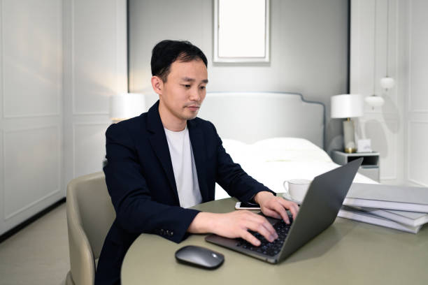 istock A young white-collar man works at home on his laptop 1387627914